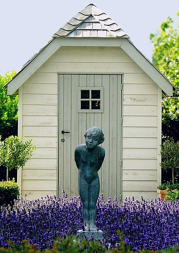 tall shed with flowers and statue - hsvsheds.com
